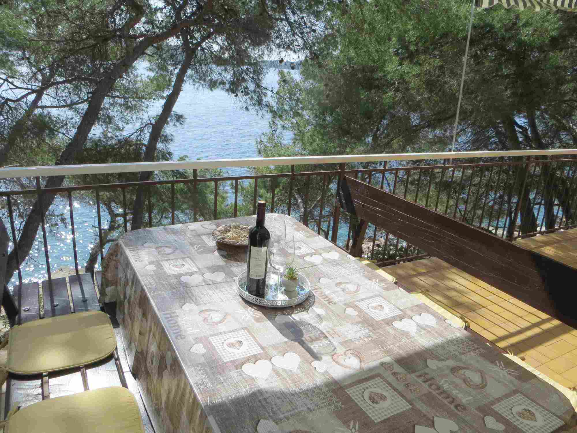 dining table at lower terrace of Villa V and seaside below